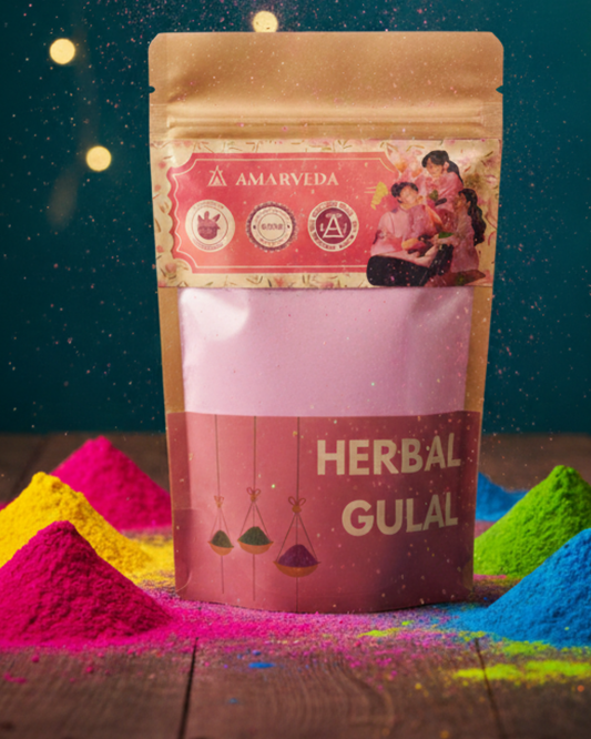 Amarveda herbal gulal packaging with colorful gulal powder on a wooden surface.